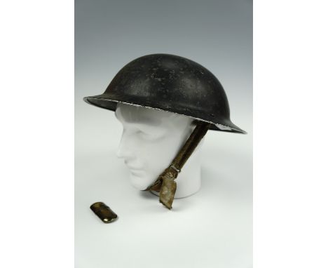 A Second World War British steel helmet shell together with a brass "Tommy" cigarette lighter