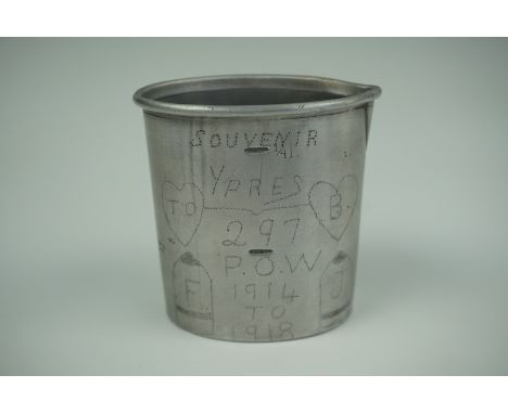 A Great War German drinking cup bearing an engraved inscription "Souvenir Ypres 297 POW, 1914 to 1918" with depictions of hea