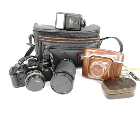 A Minolta X-700 camera, Tokina S2-X 60-300mm 1:4-5.6 lens, Cobra D300 flashgun, Agfa Ambi Silette camera together with a West