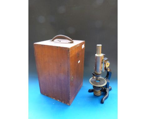 A cased Watson & Sons brass microscope with turning bed and degree scale to edge and adjustable filter below