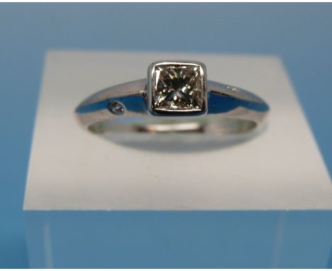 An 18ct white gold ring set with a solitaire princess cut diamond of approx 0.4ct and an inset diamond to each shoulder (size