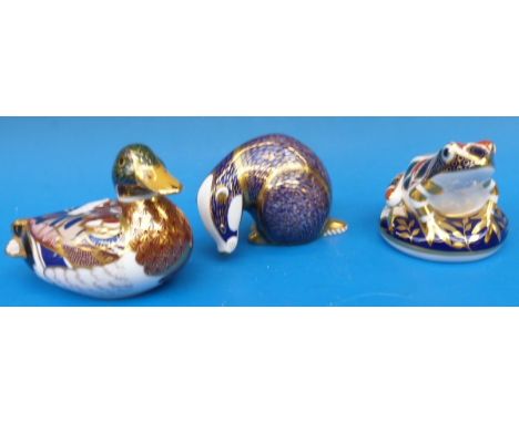 Three Royal Crown Derby paperweights comprising a badger, toad and duck.