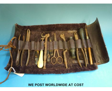 A 19th century roll of dental or field surgeons tools including scalpels, some marked Savigny & Co., including ebony and tort