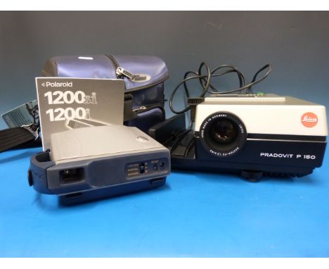 A Polaroid 1200 si camera and a Leica projector 