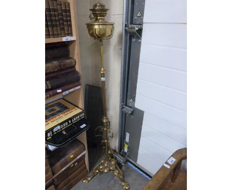 An extending brass lamp with English Juno burner, height 142cm