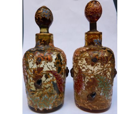 A pair of Moser enamel and gilt Bohemian amber glass scent bottles, both bodies and stoppers enamelled with oak leaves and in