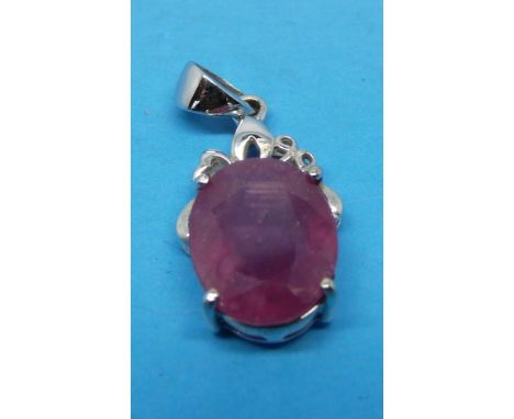 A 14k white metal pendant set with a single ruby 