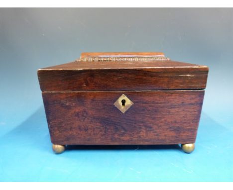 A 19thC rosewood sarcophagus tea caddy raised on brass ball feet, width 21cm