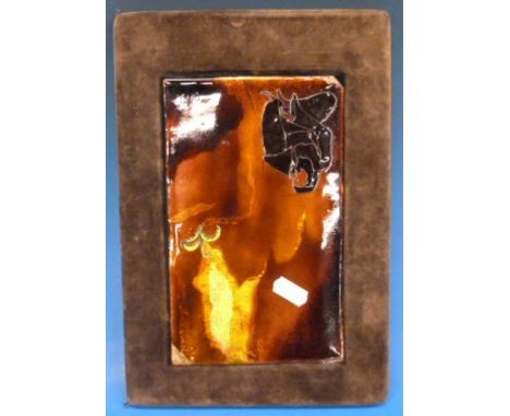 An enamel plaque with monogram to the bottom right 
