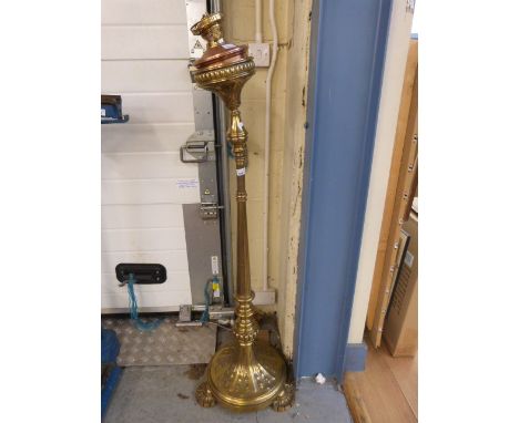 A heavy brass extending lamp raised on three segmented feet with Duplex burner 