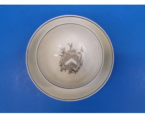 An 18thC Worcester armorial tea bowl and saucers.  Paper stickers to base including "Geoffrey Hutchinson" and "The Arms of So
