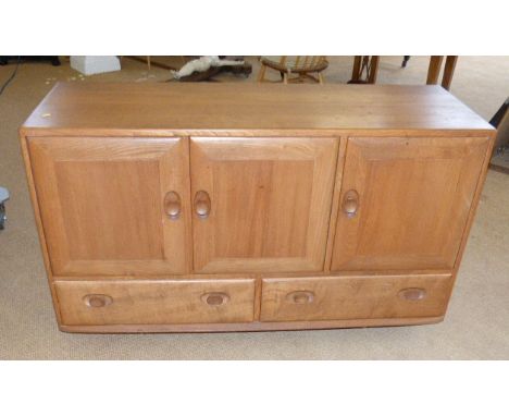 Ercol sideboard enclosing three cupboards and two drawers to base, 121cm wide, 44cm deep and 76cm tall Condition reports are 