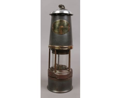 A William Maurice baby wolf miners lamp with brass vent slide and presentation plaque; presented by the British Association o