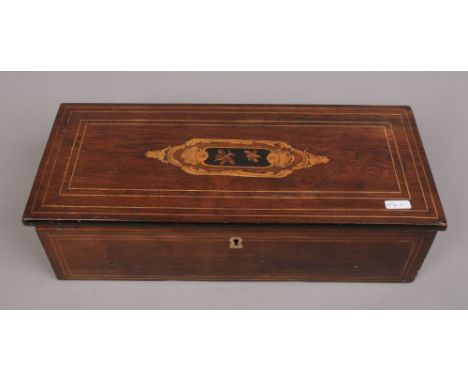A Victorian inlaid music box.Condition report intended as a guide only.In need of restoration comb with four missing teeth an