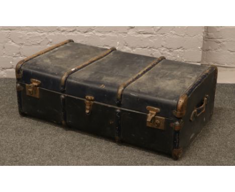 A vintage metal bound travel trunk.