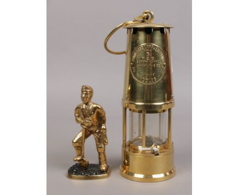An Eccles type 6 miners re-lightable protector lamp along with a brass figure of a coal miner.