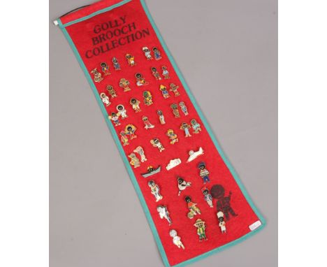 A set of Robertson's advertising enamel badges on felt display banner, 42 badges.