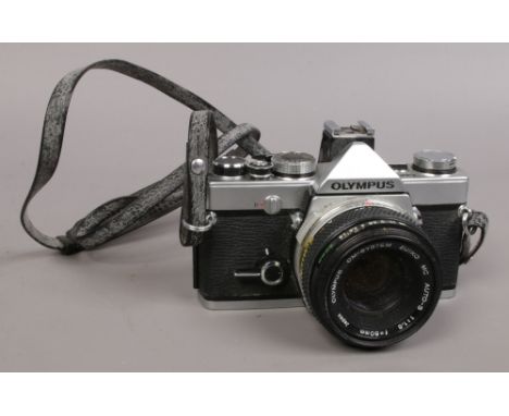 An Olympus OM - 1N 35mm SLR camera with Olympus OM - system Zuiko f=50mm lens.