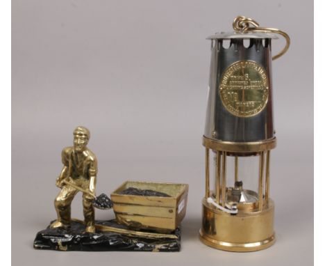 An Eccles type 6 brass and chrome miners re-lightable protector lamp along with a brass figure of a coal miner.