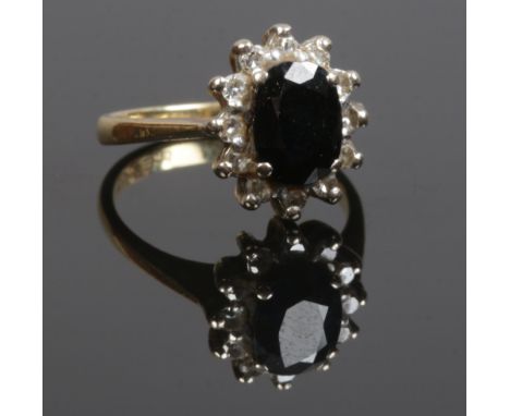 An 18ct gold sapphire and diamond cluster ring, size K 4.47 grams.