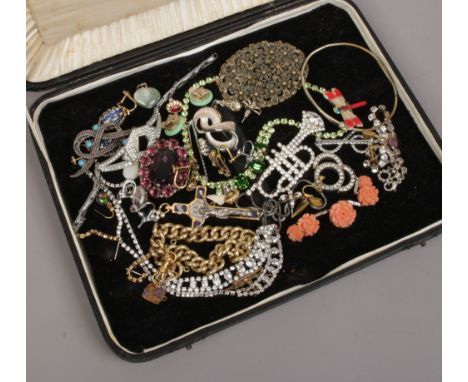 A case of mostly vintage costume jewellery including white paste set brooches, necklace, along with jade effect earrings, yel