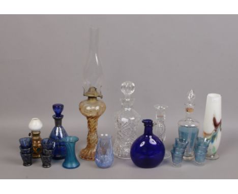 A group of collectable glassware including an oil lamp, cut glass decanter, liqueur set, art vases etc.