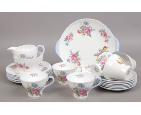 A 21 piece Shelley fine bone chain tea service decorated with sprays of summer flowers with one extra cup.