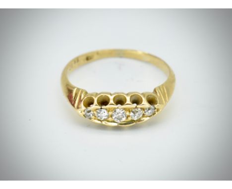 An 18ct yellow gold five stone diamond ring. The ring with inset 5 stones to a gypsy setting to a plain tapering shank.&nbsp;