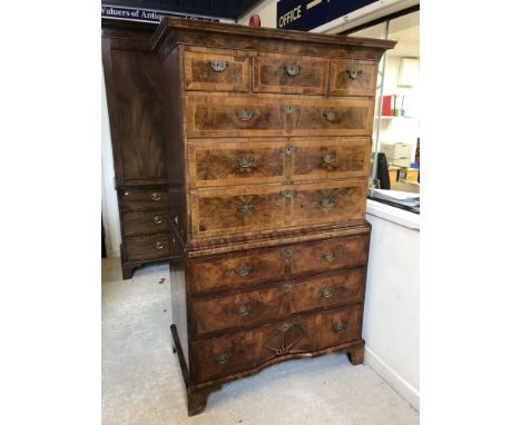 An early 18th Century walnut, feather and cross-banded chest on chest, the moulded cornice above three short drawers and thre