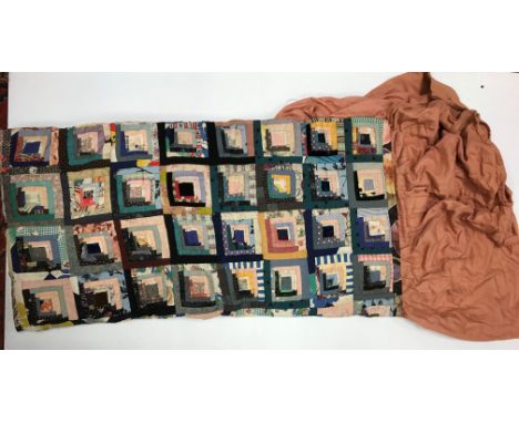 A vintage patchwork quilt mounted as a bedspread