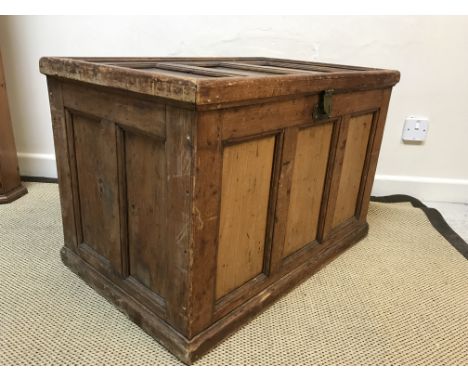 A vintage pine trunk with panelled top and sides, raised on a plinth base, 78.5 cm wide x 49.5 cm deep x 52.5 cm high, togeth