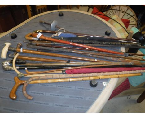 A collection of walking sticks to include a Victorian malacca cane ivory handled stick with silver ferrule, another silver fe