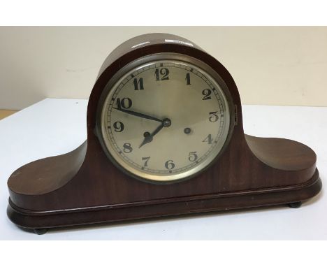 An early 20th Century mahogany cased mantel clock, the circular silvered dial with Arabic numerals, 27 cm high x 50 cm wide