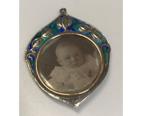 An Edwardian silver and enamel decorated pendant set with pendant locket (by William Hair Haseler, Birmingham 1905), 4.5 cm l