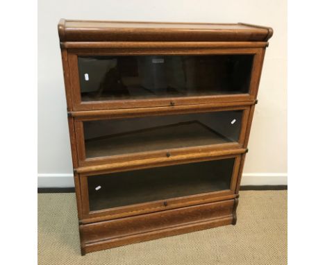 An oak three section Globe Wernicke bookcase of typical form, 87 cm wide x 27 cm deep x 108 cm high