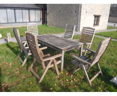 A slatted teak garden table and six folding elbow chairs bearing "Swan Hattersley Garden Furniture" labels CONDITION REPORTS 