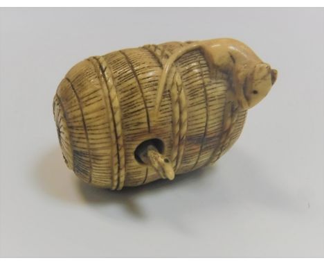 A 19th Century ivory netsuke in the form of a basket with rat on top and a articulated snake poking its head out, 3.5 cm long