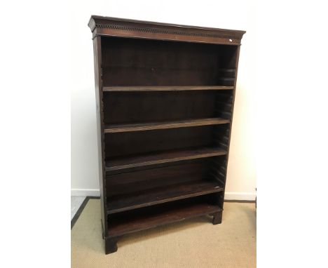 A mahogany adjustable bookcase, the top with dentil decoration, raised on bracket feet, 122.5 cm wide x 31 cm deep x 183.5 cm