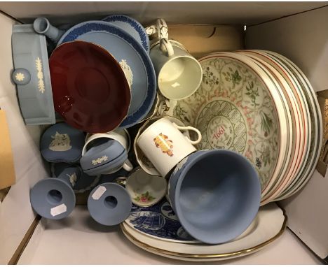 A collection of nine items of modern Wedgwood blue Jasper ware including a pair of candlesticks, three lidded trinket boxes, 