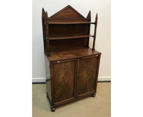 An early 19th Century mahogany Gothic Revival chiffonier, the two shelf superstructure over two figured panelled doors enclos