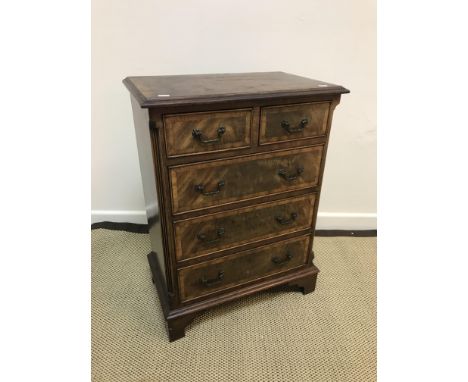 A modern mahogany and cross-banded chest in the Georgian style, the top with moulded edge above two short and three long grad