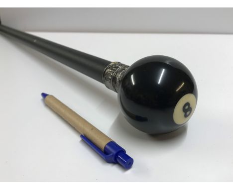 A decorative walking stick, the finial set as a No. 8 pool ball, with textured black metal shaft, approx 90.5 cm high CONDITI