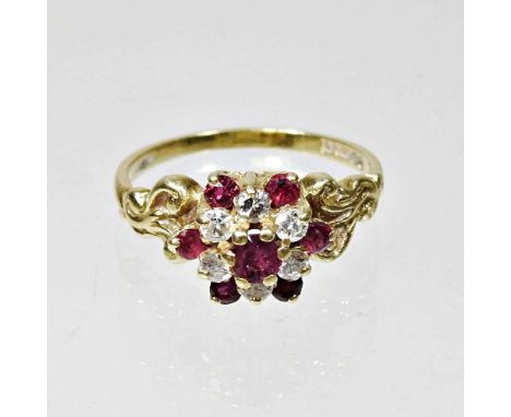 An 18 carat gold diamond and ruby set cluster ring, size N