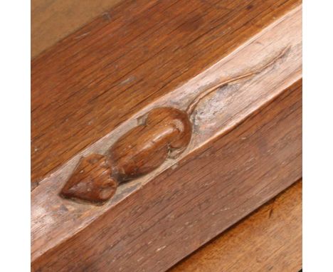 Robert 'Mouseman' Thompson of Kilburn (1876-1955), an oak fireplace fender, having a thumb-moulded edge, adzed surface, with 