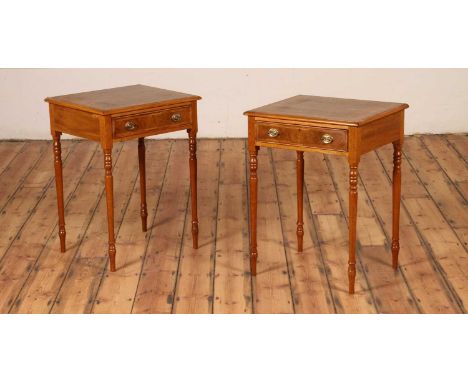 A pair of walnut lamp tables, each having a frieze drawer and standing upon turned legs, h.77cm, w.57cm, d.48cm