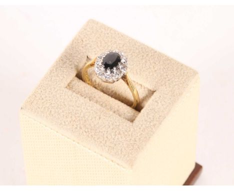An 18 carat gold sapphire and diamond cluster ring, size P