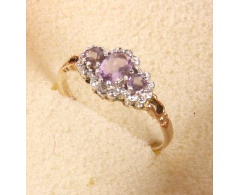 A 9 carat gold three-stone amethyst dress ring, size P