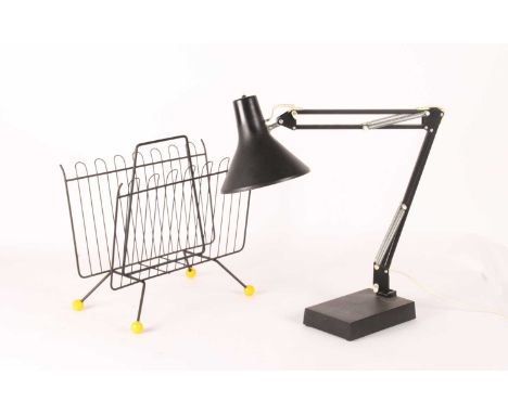 A black painted metal Atomic style magazine rack, mid 20th century, together with a black painted metal angle poise desk lamp