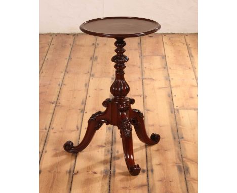A Victorian carved mahogany lamp table, having a circular dish top above a carved tripod base, bearing a paper label for Will