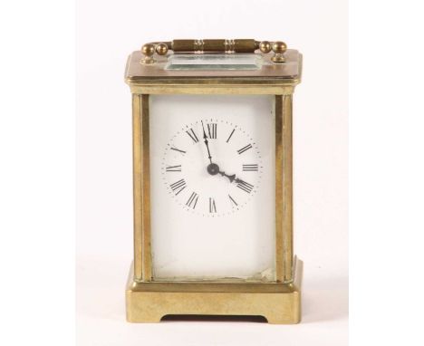 A brass carriage clock, 20th century, the enamel dial showing Roman numerals, having visible platform escapement, h.11cm